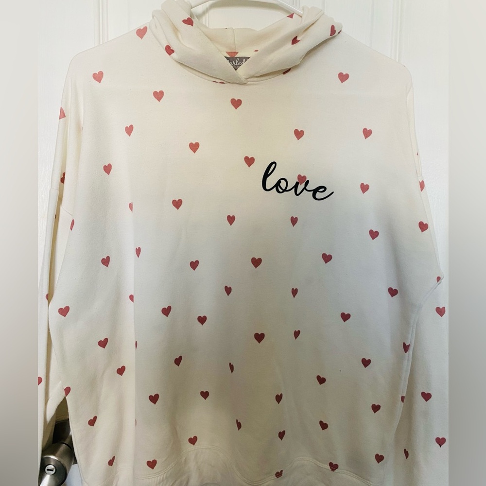Cream color hoodie with pink hearts 
Gently used 
Size large